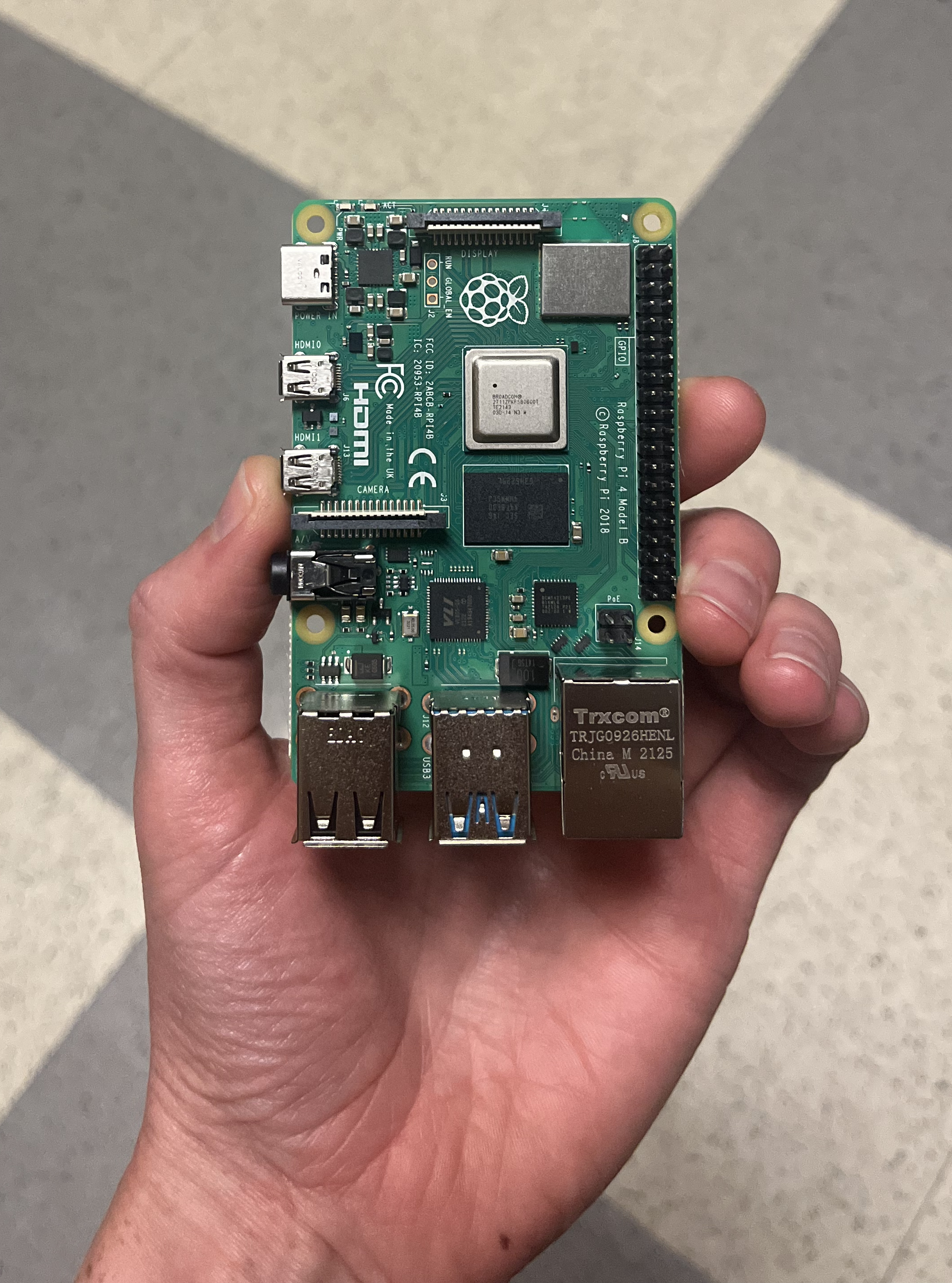 Hand holding a Raspberry Pi.